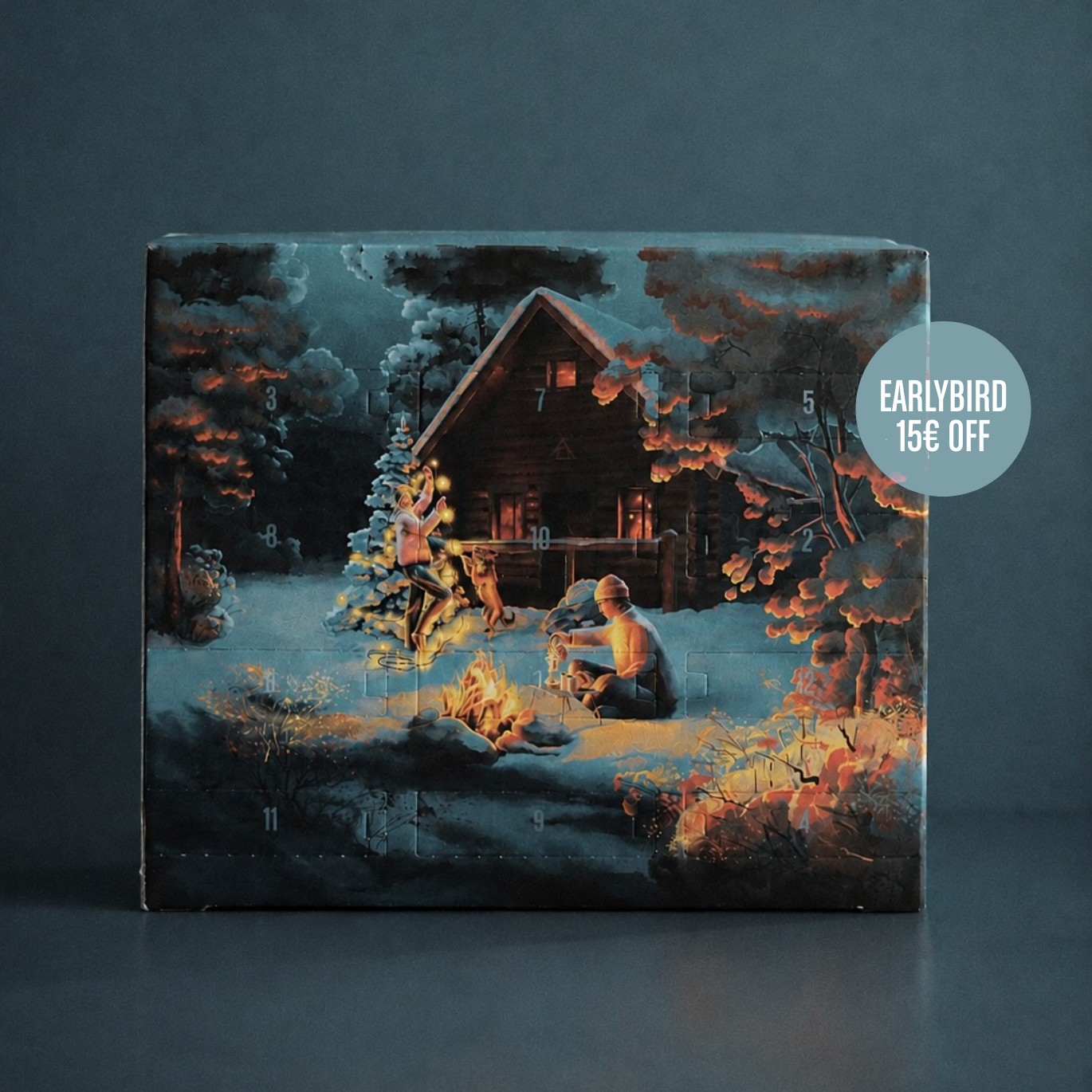 A square advent calendar box featuring a winter cabin scene with a person by a campfire in the snow, photographed against a dark gray background. A circular badge on the right reads 'EARLYBIRD 15€ OFF'.