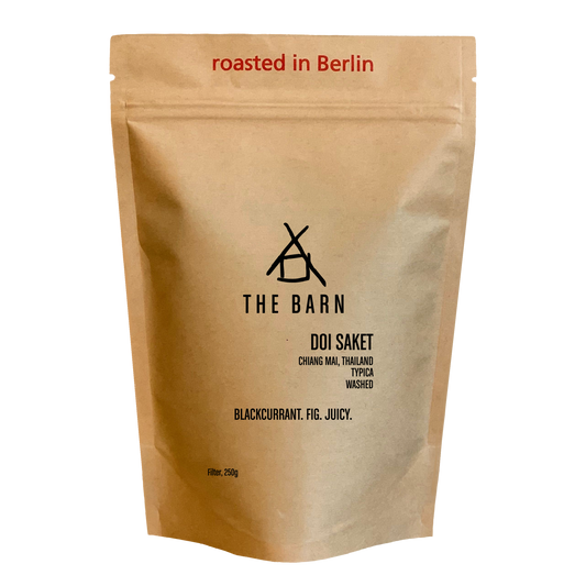 Kraft paper coffee bag with 'The Barn' branding and coffee details on a white background