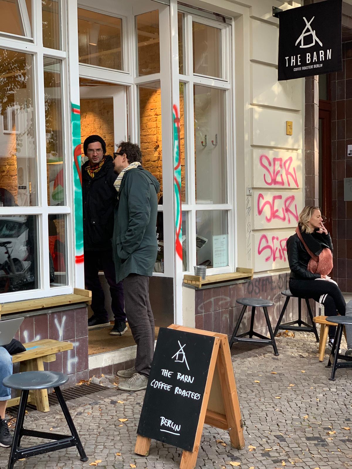 Cafe exterior, people entering the place